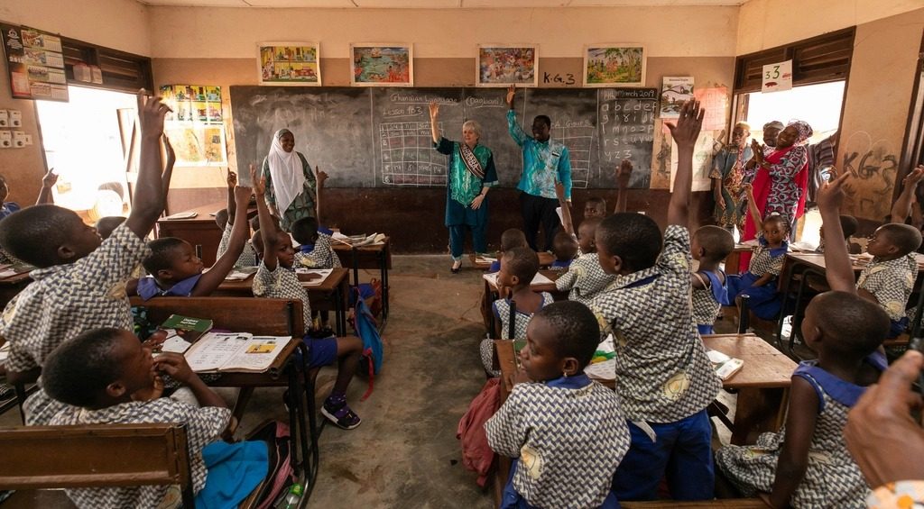 Pupils in a West African classroom raising their hands